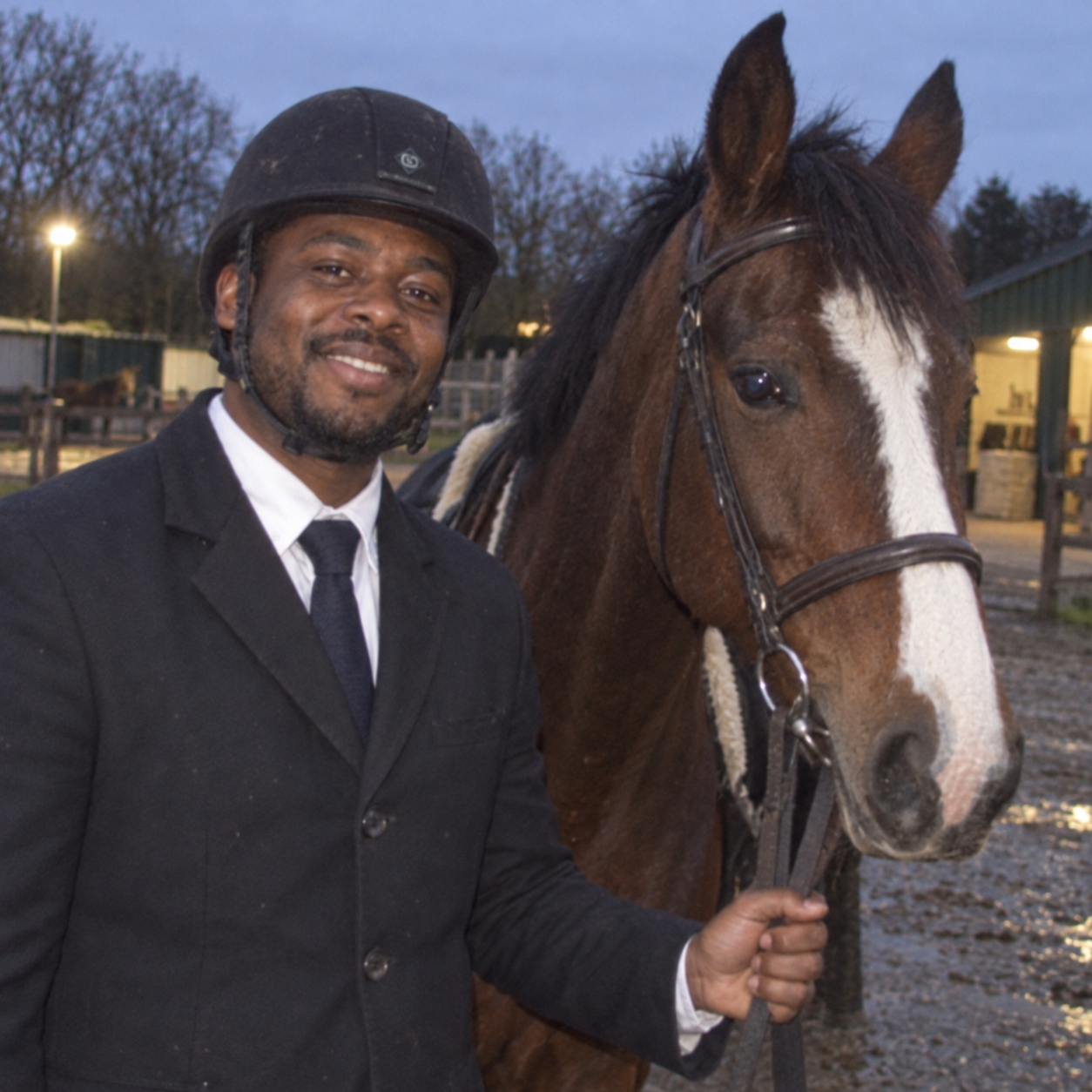 William dressed for riding beside his horse